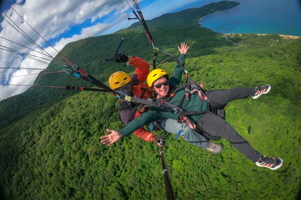 A girl making a paragliding tandem flight in Vietnam