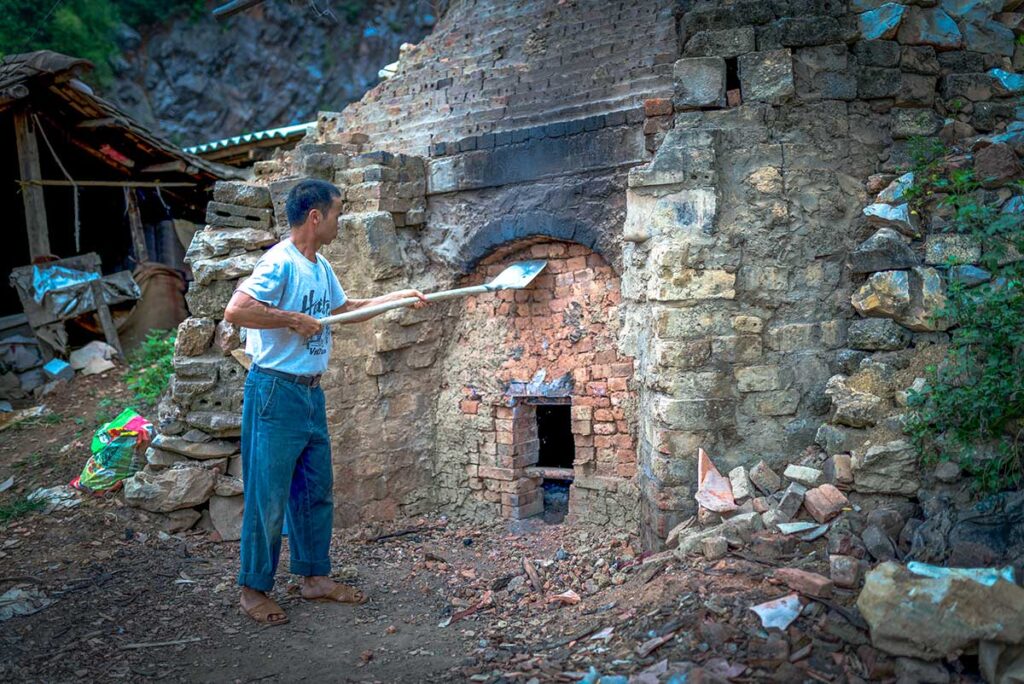 A man using a fire stove to make roof tiles at Quynh Son Village