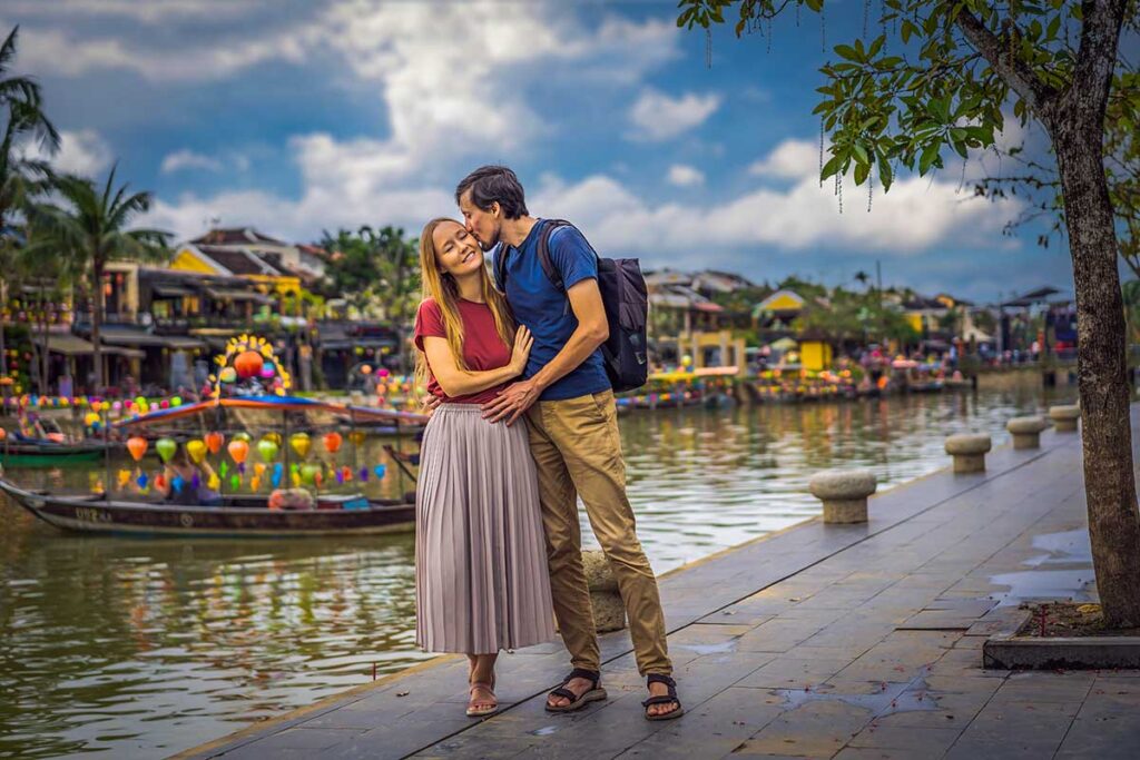 A couple kissing on the street of Hoi An on their honeymoon in Vietnam