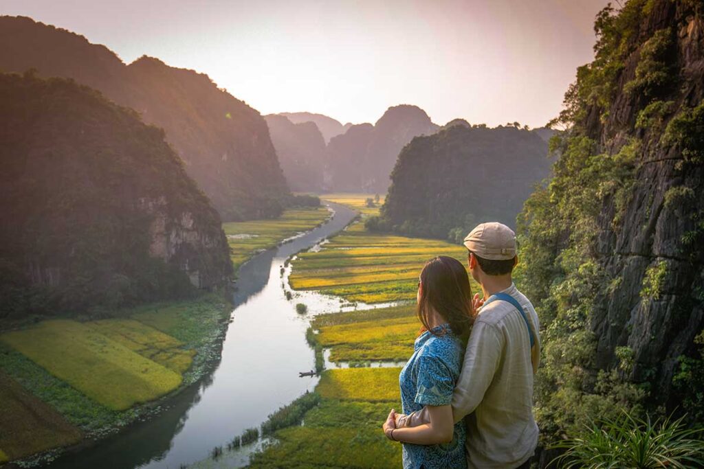 A couple watching the sunset at Tam Coc in Ninh Binh - Romantic in Vietnam