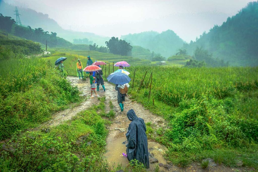 People making a trekking in Sapa during rain