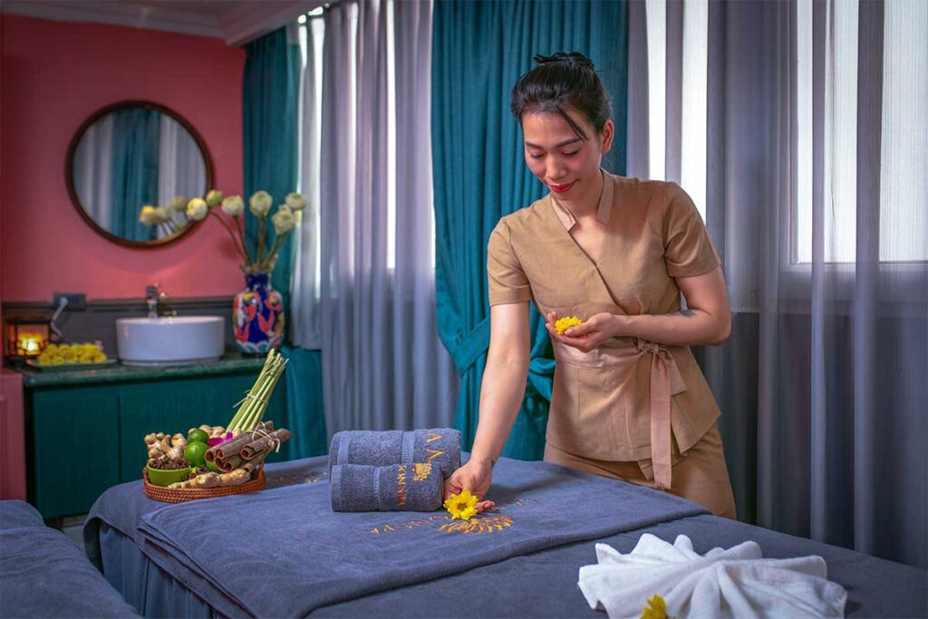 A masseuse preparing the massage table at a Spa in Hanoi