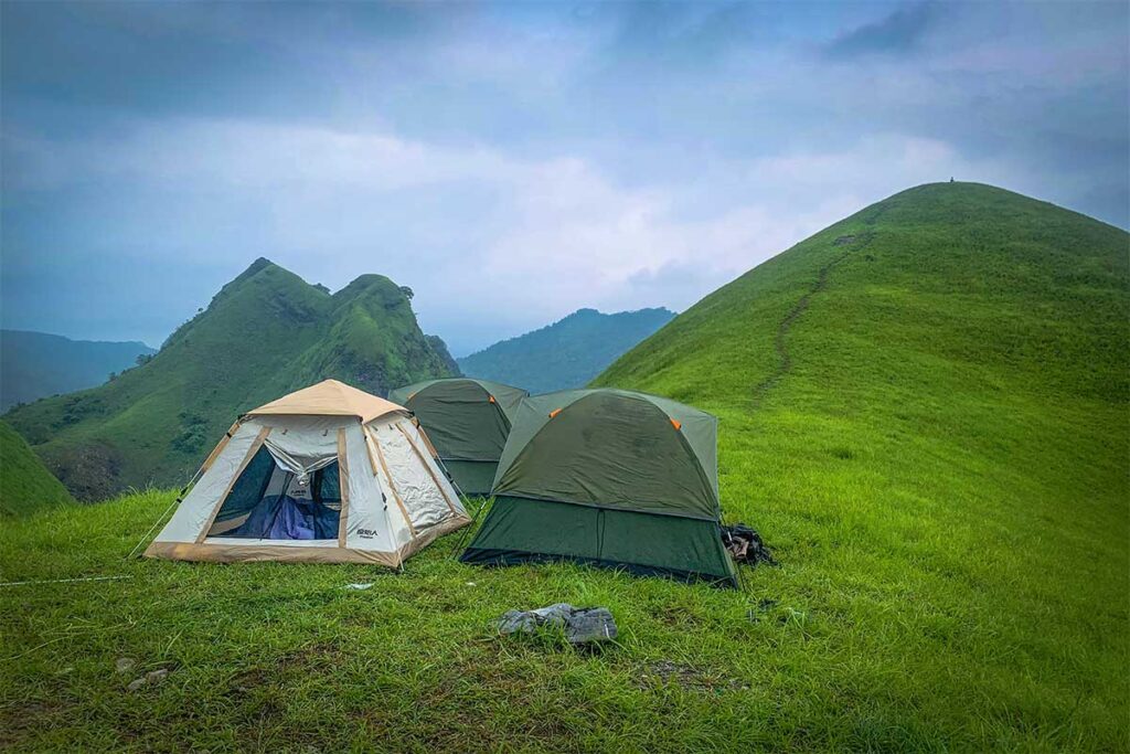 Three tents standing on top of a hill in Cao Bang at Vinh Quy Grass Hill