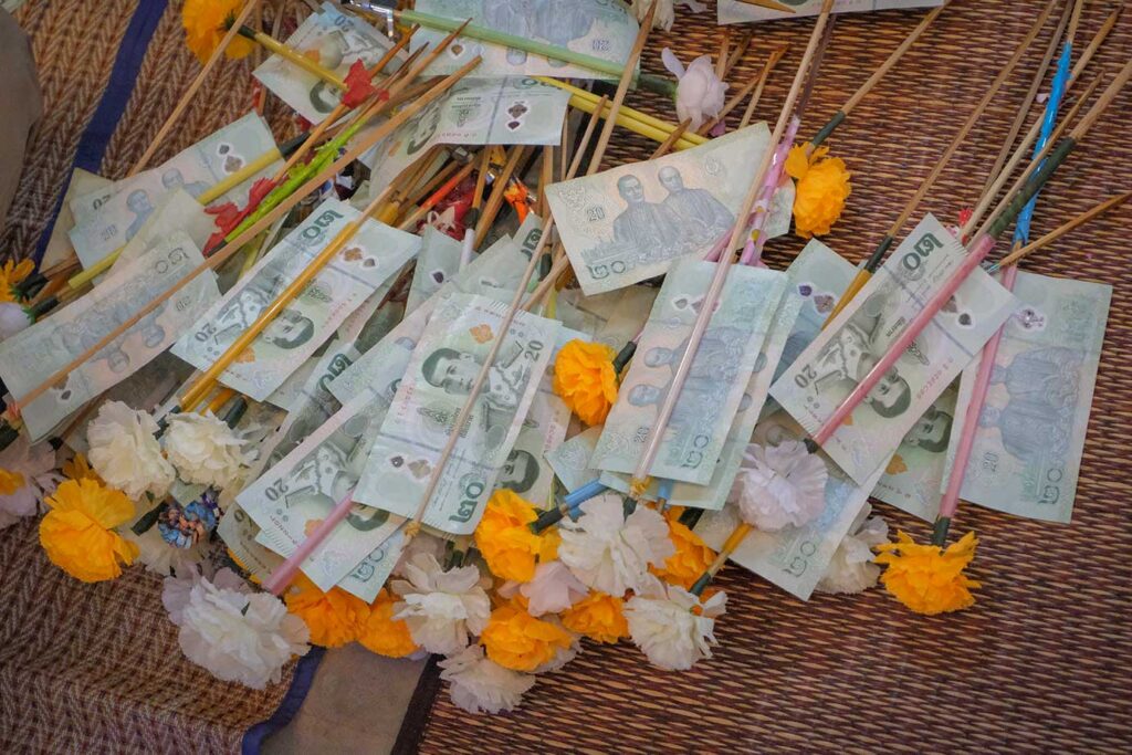 Money trees decorated with Thai banknotes for Kathina Festival offerings.