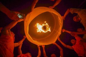 People releasing sky lanterns during the Ok Om Bok Festival in the Mekong Delta, a Khmer celebration in Tra Vinh with prayers for good harvest and prosperity.