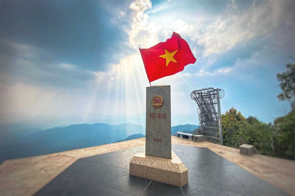 A border milestone at A Pa Chai, marking the meeting point of Vietnam, Laos, and China.