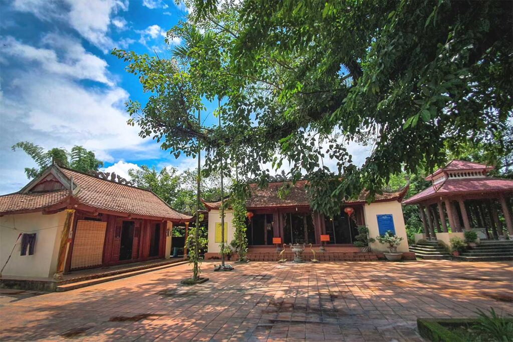 The ancient Ban Phu Citadel, featuring traditional temples, historical structures, and a towering tree within the complex.