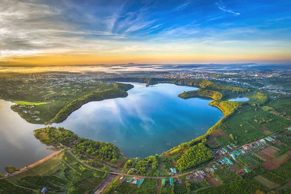 A breathtaking aerial perspective of Bien Ho Lake, showing its emerald waters and surrounding greenery near Pleiku, Gia Lai.