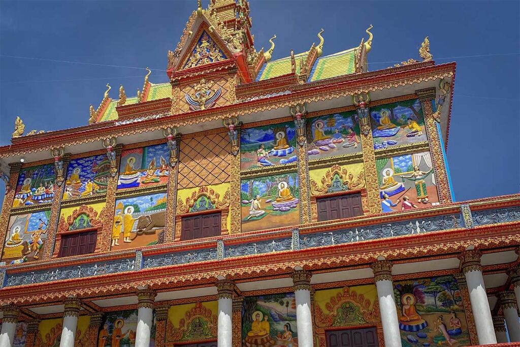 Bo Tum Vong Say Khmer Pagoda in Hau Giang Province, Vietnam – colorful facade decorated with detailed Buddhist murals and golden ornaments.
