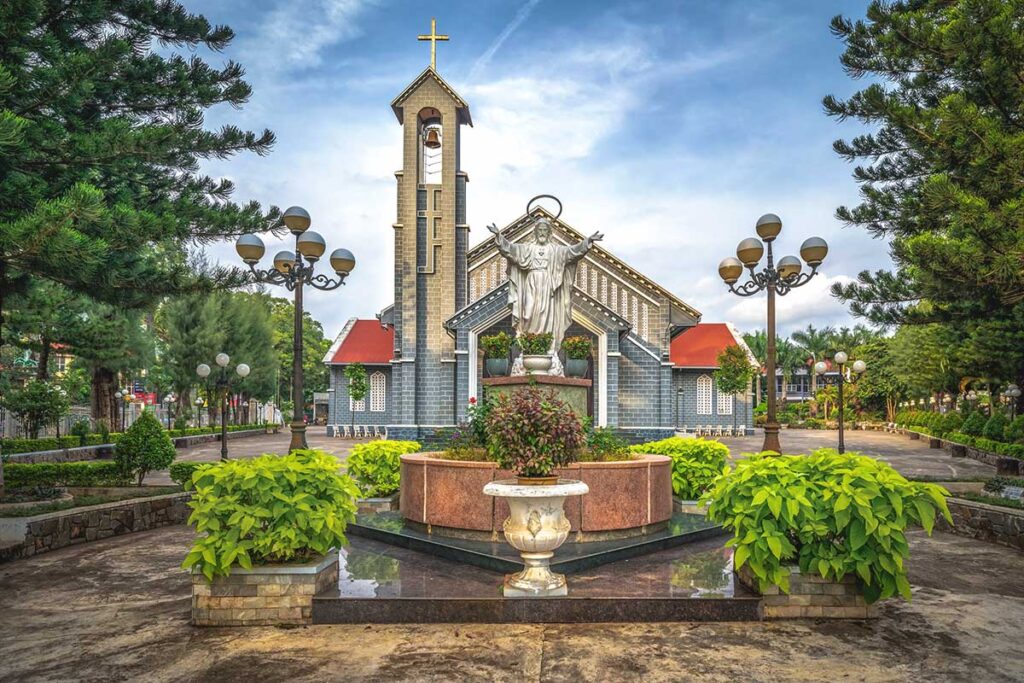 The exterior of Buon Ma Thuot Cathedral, showcasing its architectural design and prominent tower.