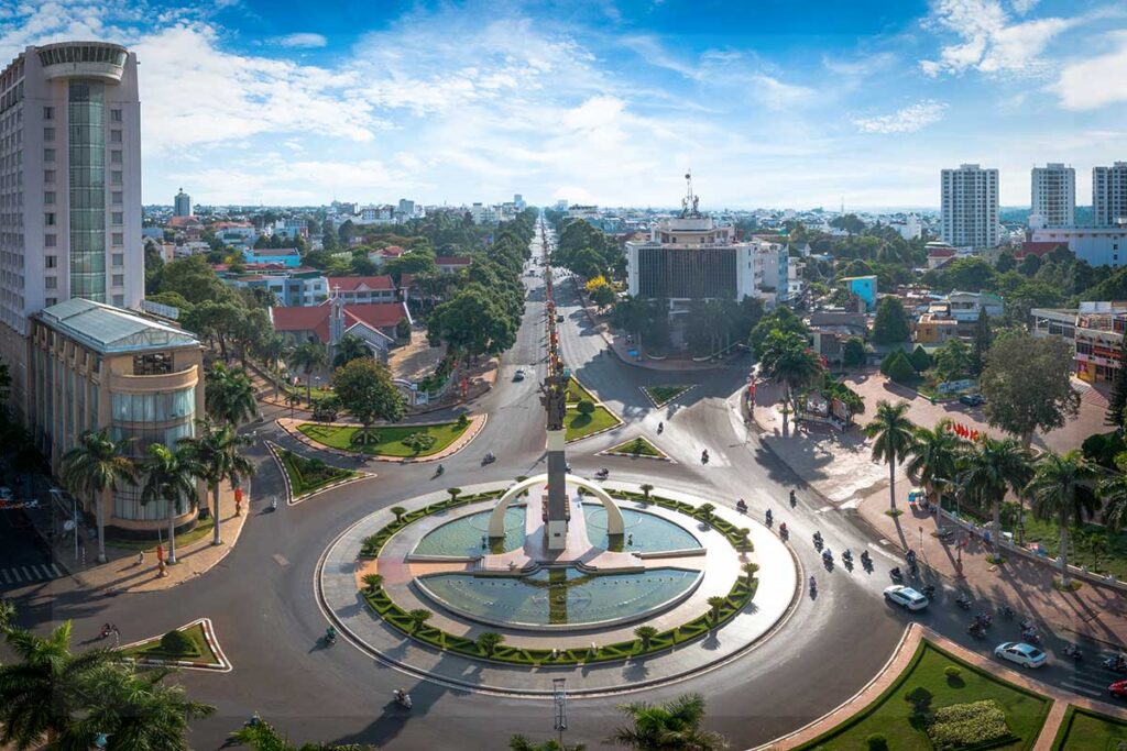 An aerial shot of the Buon Ma Thuot Victory Monument, prominently standing in the cityscape.