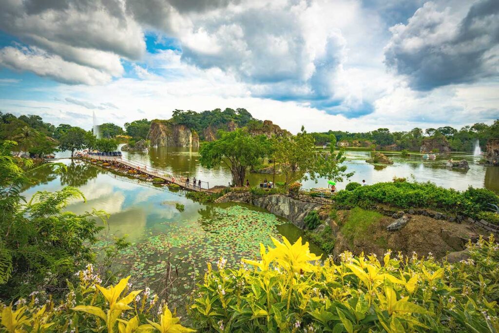 A scenic bridge stretching across a tranquil lake, located within the Buu Long Tourist Area in Dong Nai.