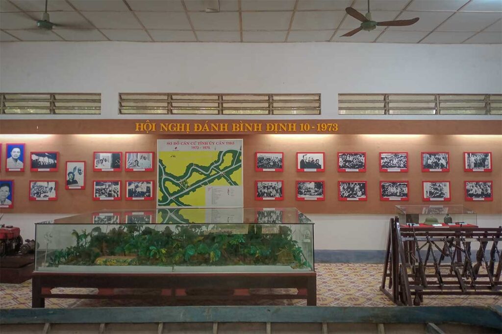Exhibition hall at Can Tho Provincial Party Committee Vestige, Hau Giang – historical display with wartime photos and maps from 1973–1975.