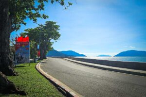 Con Dao in February – A scenic coastal road under a bright blue sky, showcasing perfect weather for exploring the island by motorbike.