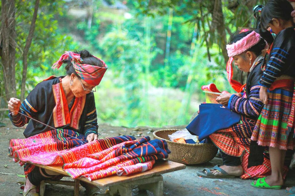 ​Two ethnic minority women engaged in traditional brocade weaving in Dien Bien Phu.​