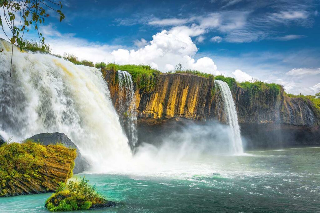 The breathtaking Dray Nur Waterfall, showcasing its immense power and misty spray as it plunges into the river.