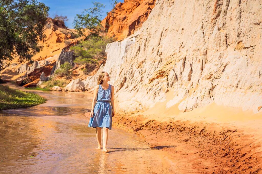 Woman walking through the Fairy Stream in Mui Ne