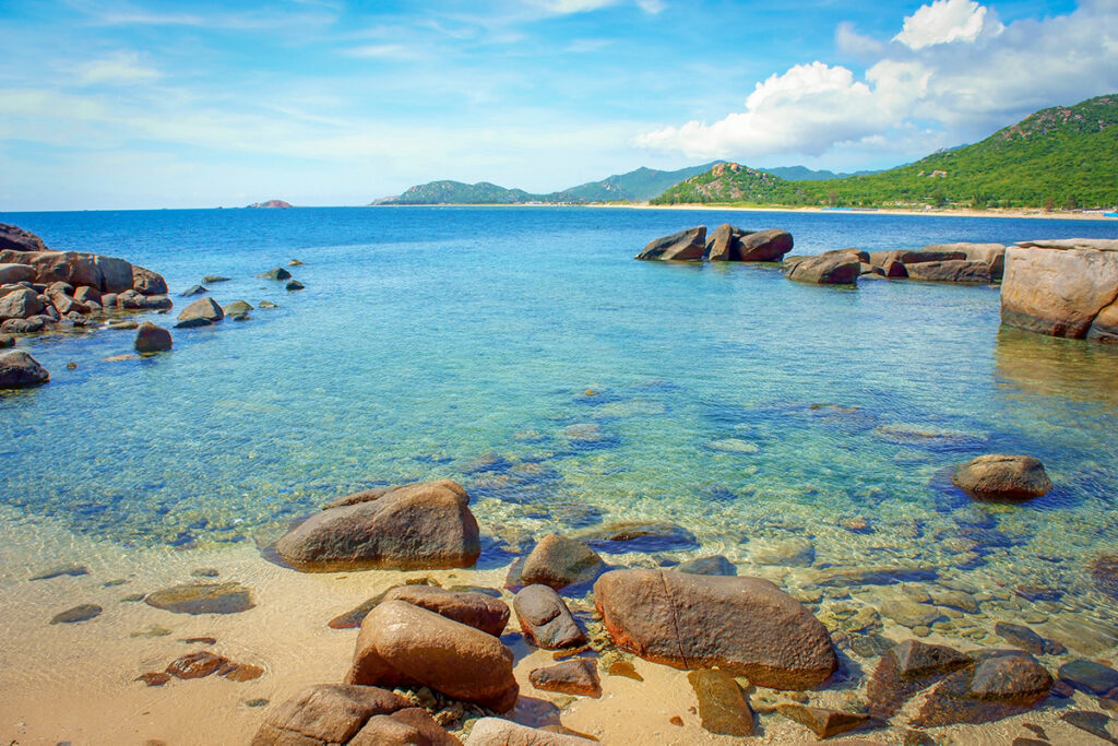 “Clear turquoise water and rocky shoreline at Hang Rai in Ninh Thuan, a famous coastal attraction