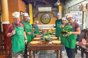 Group of travelers gathered around a table, ready to start a cooking class in Hanoi