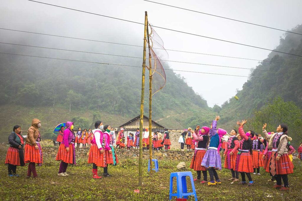 A group of ethnic Hmong woman playing a game outside for H'Mong New Year celebrations