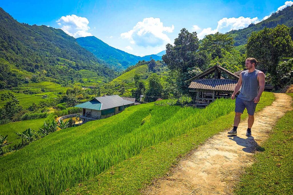 A tourist doing a trekking with views on the rice fields in Hoang Su Phi