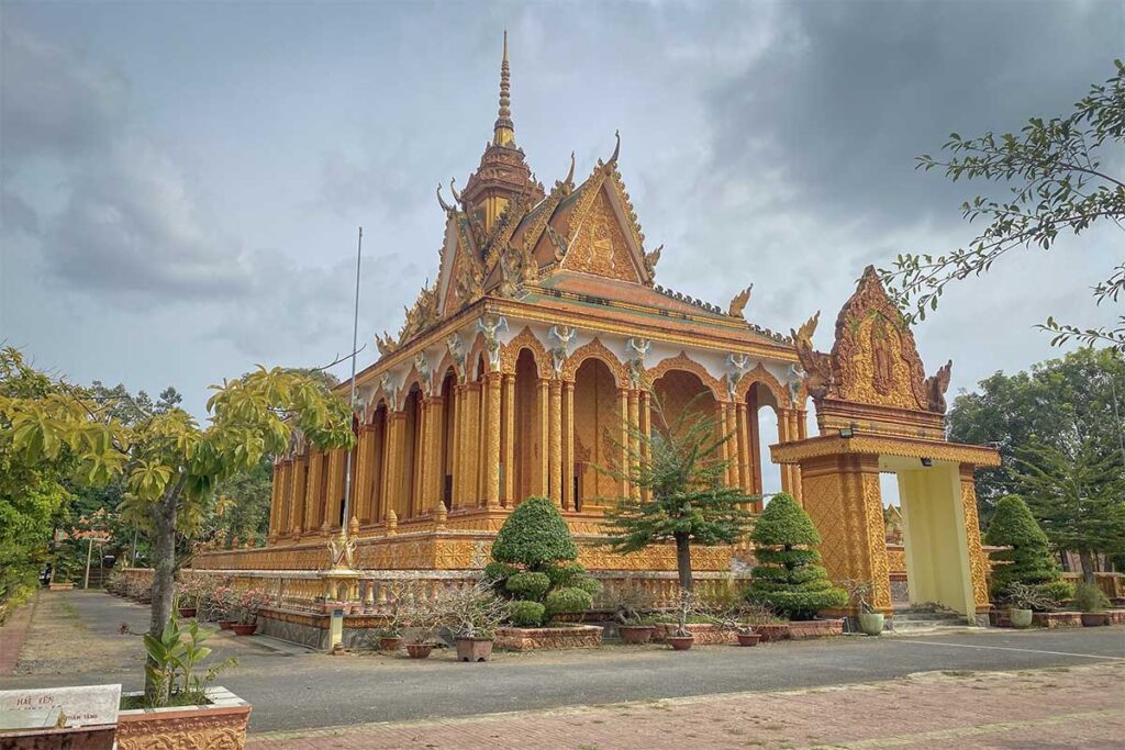 Khmer-style Kampong Ksan Pagoda with intricate golden detailing and lush surroundings, one of the many traditional temples found in Tra Vinh Province.