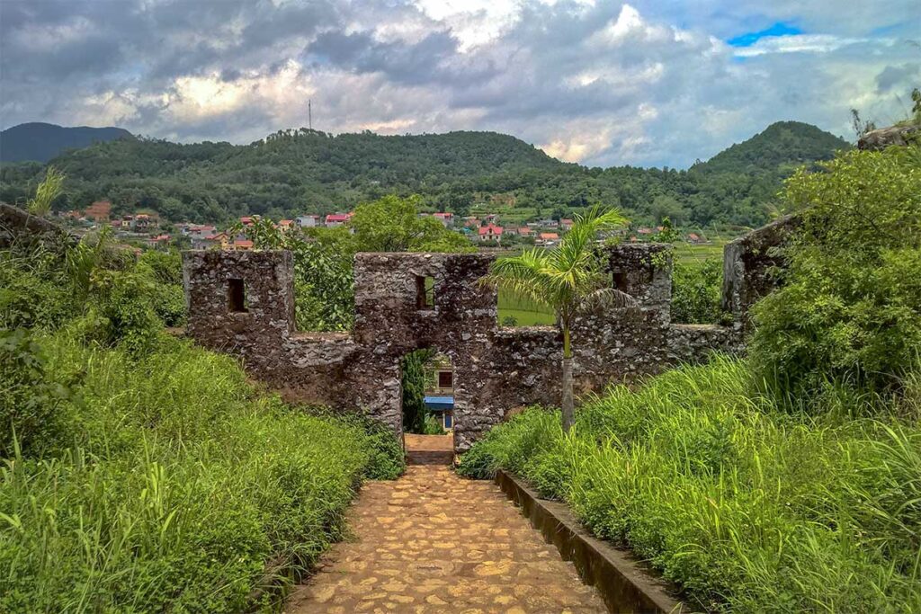 Stairs leading down the hill to a small stone gate of Mac Dynasty Citadel