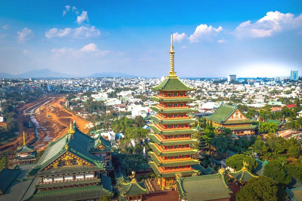 Aerial perspective capturing the grand scale of Minh Thanh Pagoda, with its intricate rooftops and towering stupa rising above.