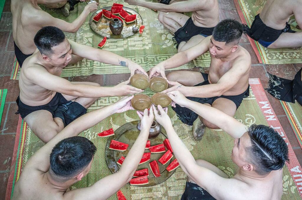 Wrestlers drinking tea and eating watermelon before the Mud ball wrestling festival