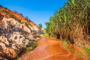 Mui Ne in March: The Fairy Stream in Mui Ne in March, with its striking red and white sand formations under a bright blue sky, highlighting the beauty of this unique natural attraction.