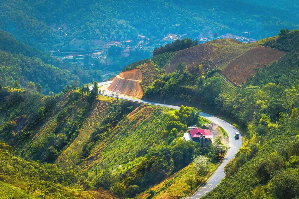 A breathtaking aerial perspective of Pha Din Pass, showcasing its curving roads through the mountains.