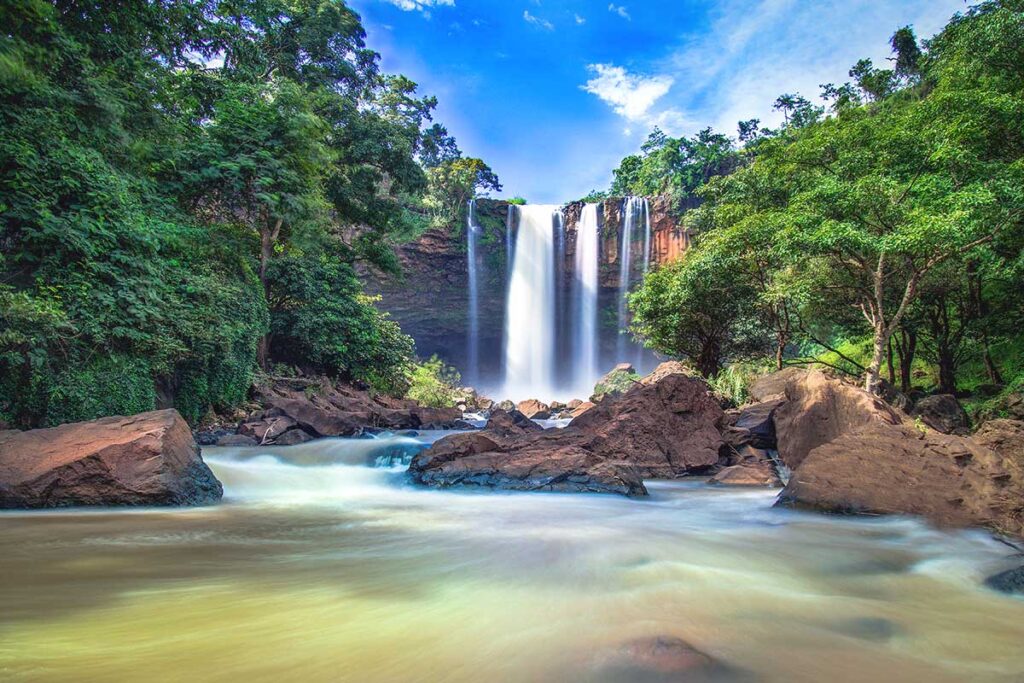 The powerful Phu Cuong Waterfall, set amidst dense tropical greenery in Gia Lai Province.