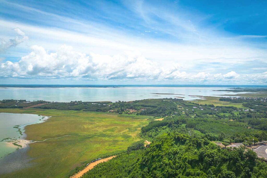 A breathtaking aerial shot of Tri An Lake, a vast reservoir in Dong Nai Province, surrounded by lush greenery.