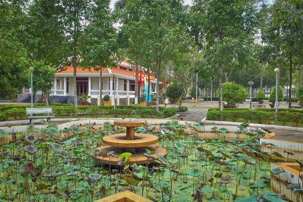Uncle Ho Temple in Hau Giang, Vietnam – cultural and spiritual site honoring Ho Chi Minh, featuring ornate altar with flowers and vases.