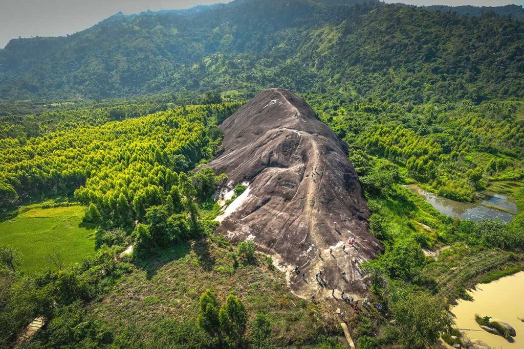 A breathtaking aerial view of Yang Tao Elephant Rock, showcasing its massive size and unique shape amidst the surrounding landscape.