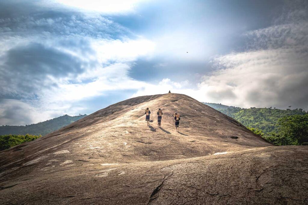 A view from atop Yang Tao Elephant Rock, capturing a few locals making their way up the smooth rock surface.