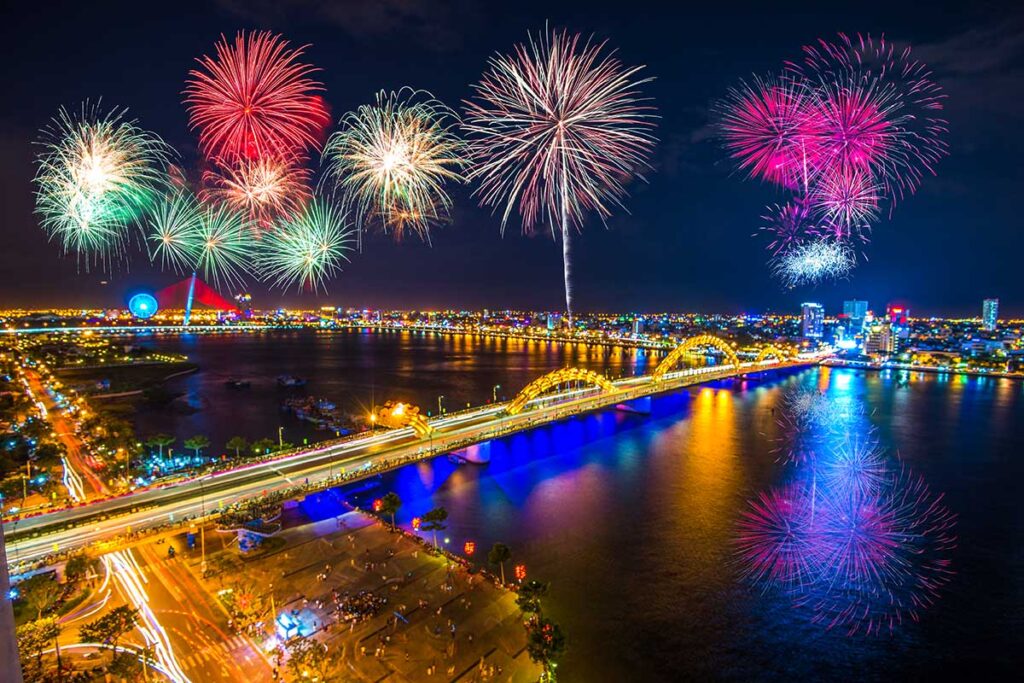 Dragon Bridge in Da Nang during Vietnamese New Year, with vibrant fireworks lighting up the night sky, celebrating Lunar New Year (Tet Festival) over the Han River.