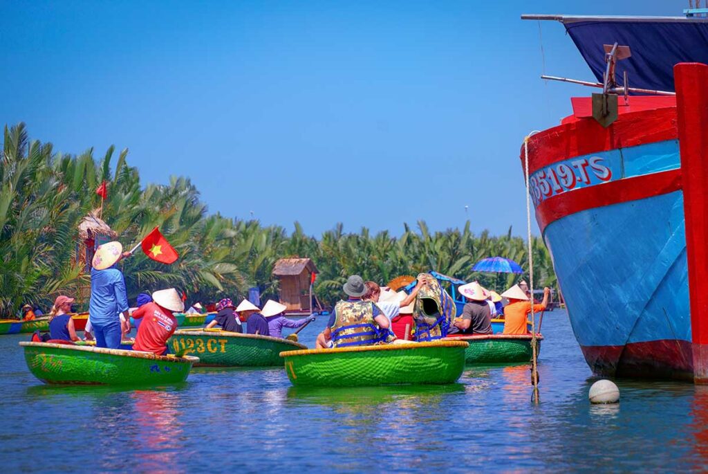 Visitors enjoying a basket boat tour in Hoi Anβs Cam Thanh Coconut Village in April, when sunny skies and calm weather make it one of the best months for outdoor activities.
