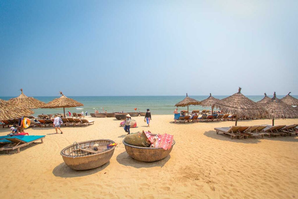 Relaxed day at An Bang Beach near Hoi An in April, when dry season peaks and the sea is calm, perfect for swimming and beachside relaxation.