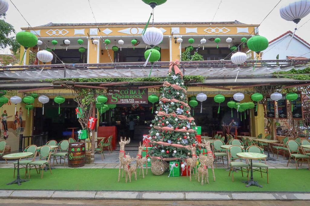 Christmas decorations at a café in Hoi An Ancient Town, featuring a festive tree and green lanterns, showing how the town blends Vietnamese and Western holiday traditions.