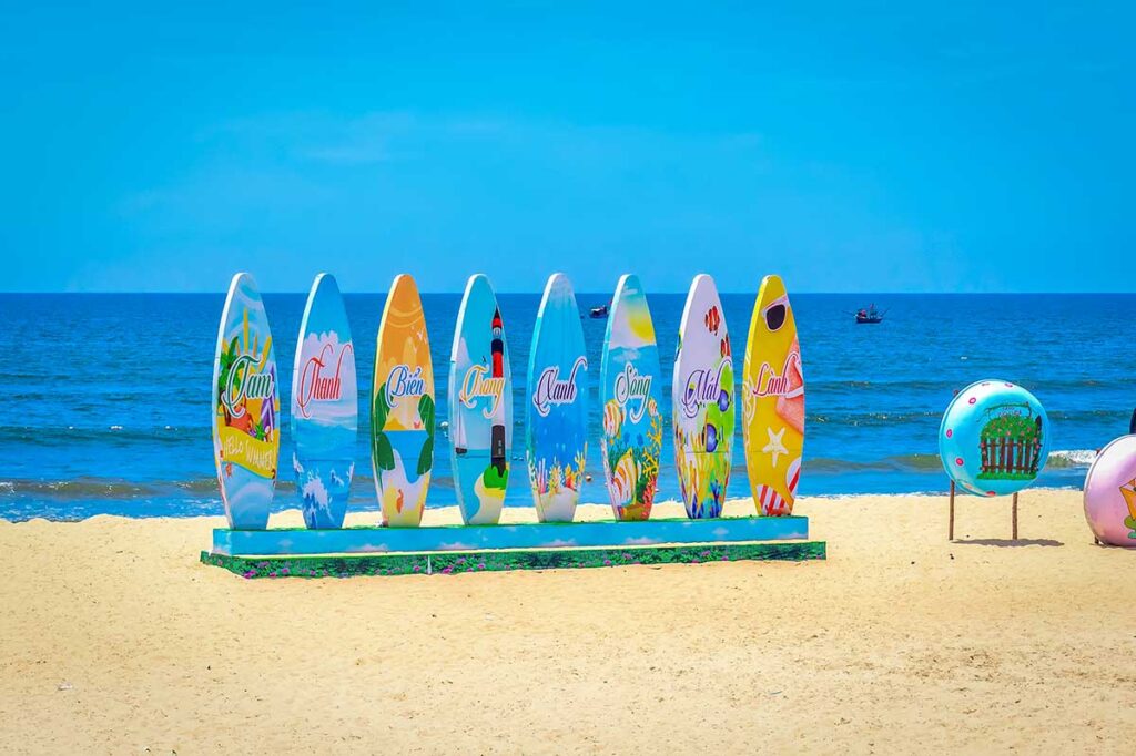 Colorful summer display on Hoi An’s beach in July, with bright skies and hot weather marking one of the most vibrant months for seaside activities.