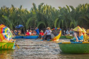 Tourists enjoying basket boat rides in Hoi An’s Coconut Village in June, when sunny weather and high temperatures make early morning tours the most comfortable time to explore.