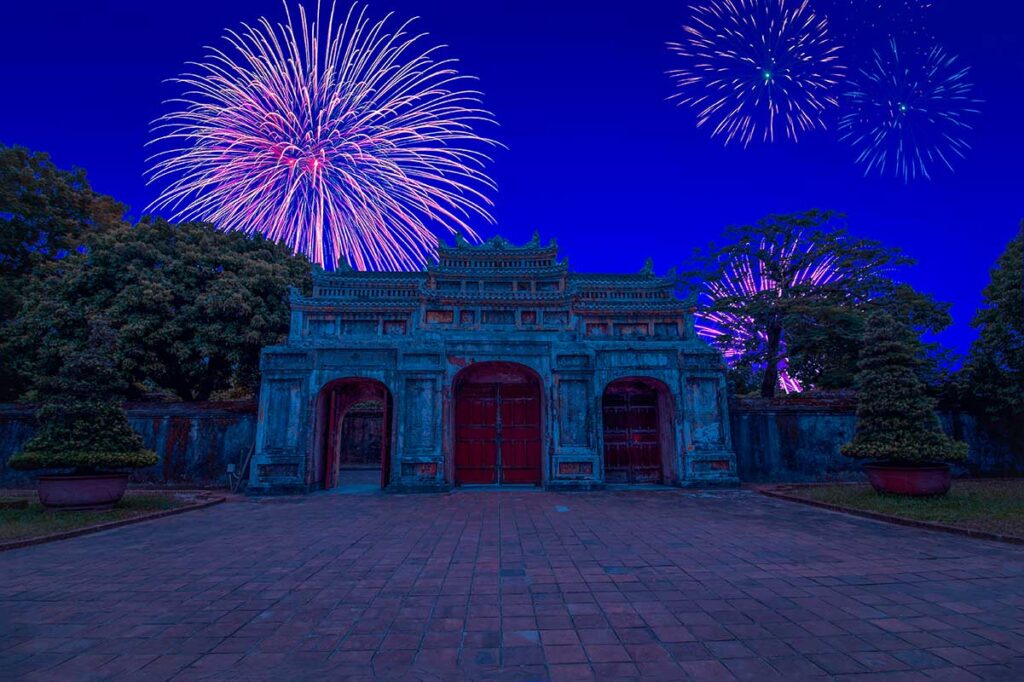 Fireworks above an ancient gate in Hue during Tet Vietnamese New Year