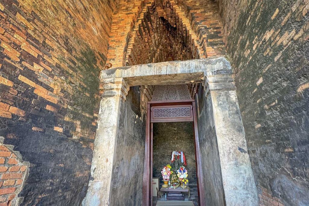 Interior of the Kalan main tower at Banh It Cham Towers with small shrine and offerings.