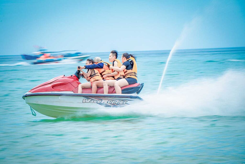 Jet ski ride at Ky Co Beach – Visitors riding a red jet ski across the clear waters of Ky Co Beach in Quy Nhon.