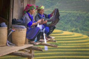 Mu Cang Chai cultural tour with Hmong women weaving traditional textiles overlooking terraced rice fields