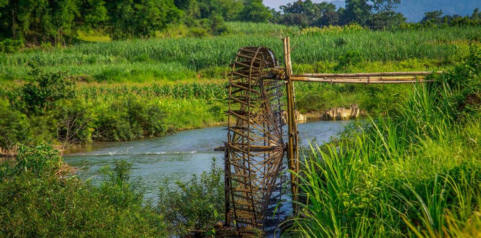 Traditional bamboo waterwheel along a river in Pu Luong Nature Reserve, a highlight of a private day tour from Mai Chau.