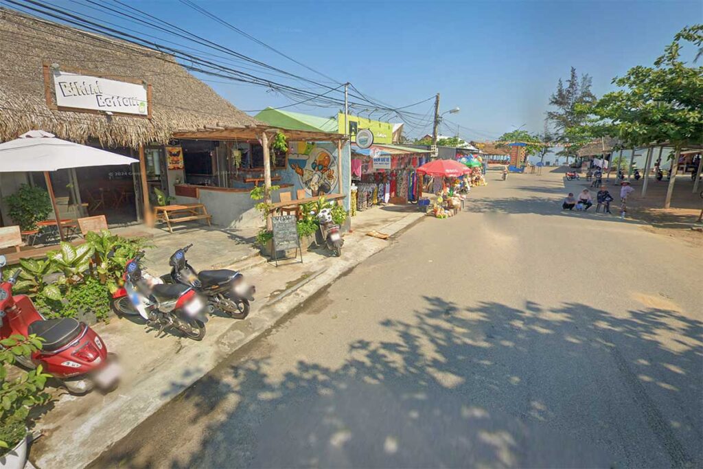 Main street of An Bang Village near Hoi An, with beach bars, souvenir shops, and relaxed local atmosphere.