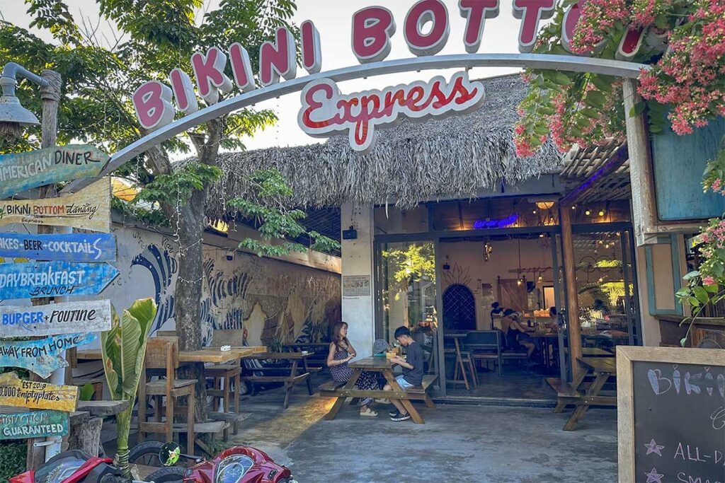 Entrance of Bikini Bottom Express restaurant at An Bang Beach Hoi An, a casual spot for breakfast, burgers, and cocktails.