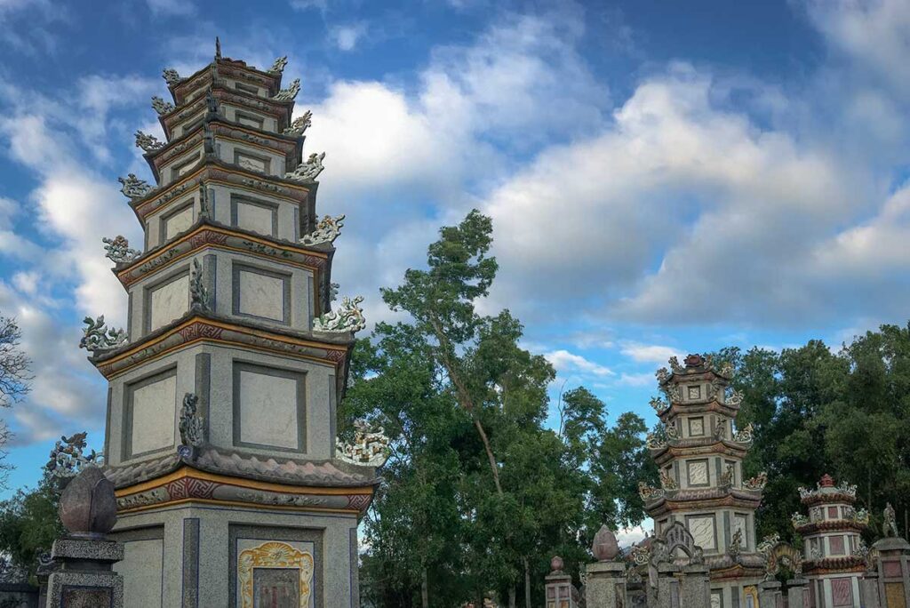 Pagoda towers at Chuc Thanh Pagoda, the oldest Buddhist temple in Hoi An, known for its peaceful garden, tall stupas, and long-standing religious heritage.